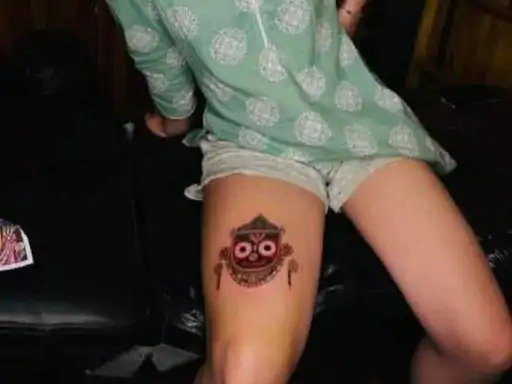 foreign woman gets lord jagannath tattooed on her thigh